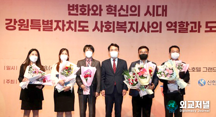 Governor Kim Jin-tae of Ganwon-do Province (fourth from left) and other officials take a commemorative photo at the opening ceremony of the 21st<br>
Gangwon-do Social Welfare Society Conference.