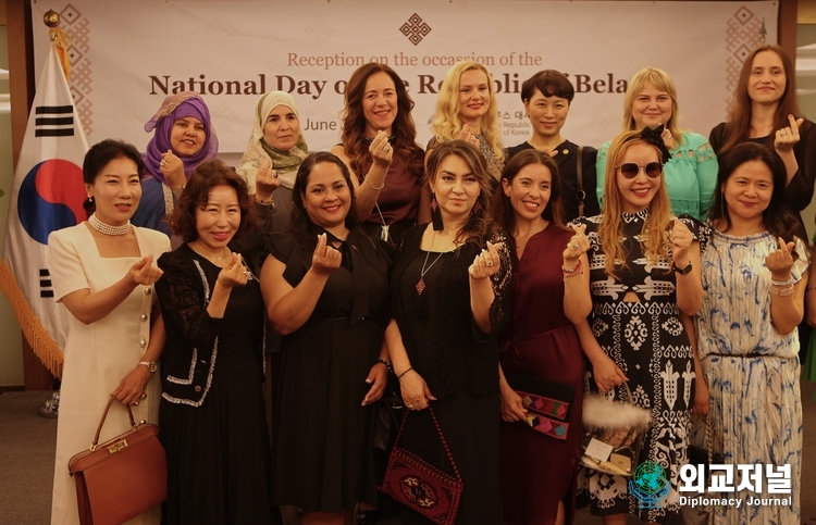  Mrs. Chernetsky, the spouse of Amb. Andrew Chernetsky of Belarus in Seoul (fourth from left), presents a “love” sign with spouses of foreign ambassadors and Korean guests at a reception to mark the Independence Day of Belarus held at Lotte Hotel in Seoul on June 28.