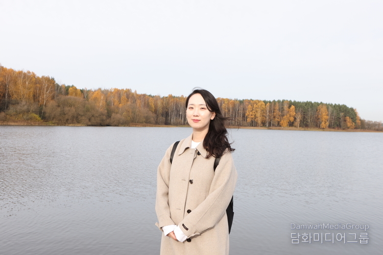 자슬라브스코예 호수(일명 ‘민스크 바다’)를 배경으로 한 김선아 『Diplomacy Journal』 특파원 기자. 가을빛으로 물든 숲과 잔잔한 호수 위로 부드러운 햇살이 내려앉은 가운데, 김 기자가 벨라루스의 평화로운 자연 속에서 현지 문화·관광 취재를 진행하고 있다.(사진-최동호 국장)